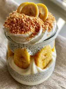 Macro photo of banana cream pie chia pudding showing visible black seeds and vanilla bean specks in a creamy white base.