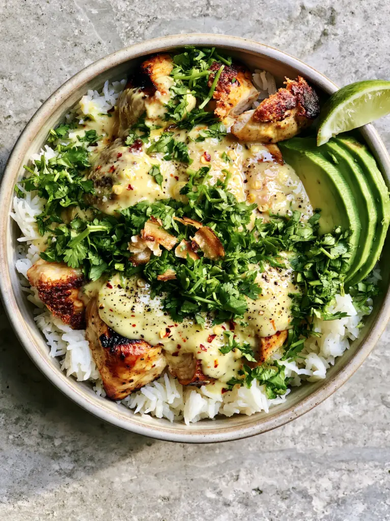 Coconut Chicken Rice Bowl: The Ultimate Creamy 30-Minute Tropical Dinner 2 Overhead shot of a Coconut Chicken Rice Bowl with charred chicken breast and creamy pale-yellow sauce.