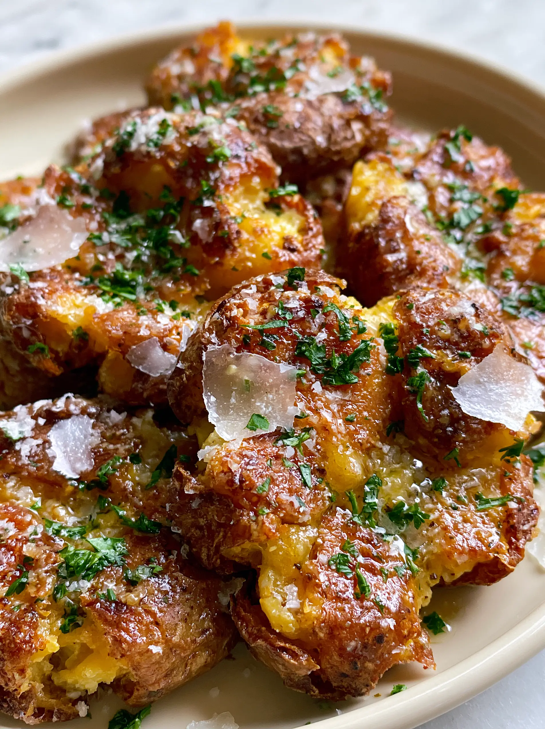 Smashed Baby Potatoes with Ultra-Crispy Garlic Butter and Parmesan 3 Macro view of smashed baby potatoes showing shatter-crisp edges and melted garlic butter. (smashed baby potatoes)