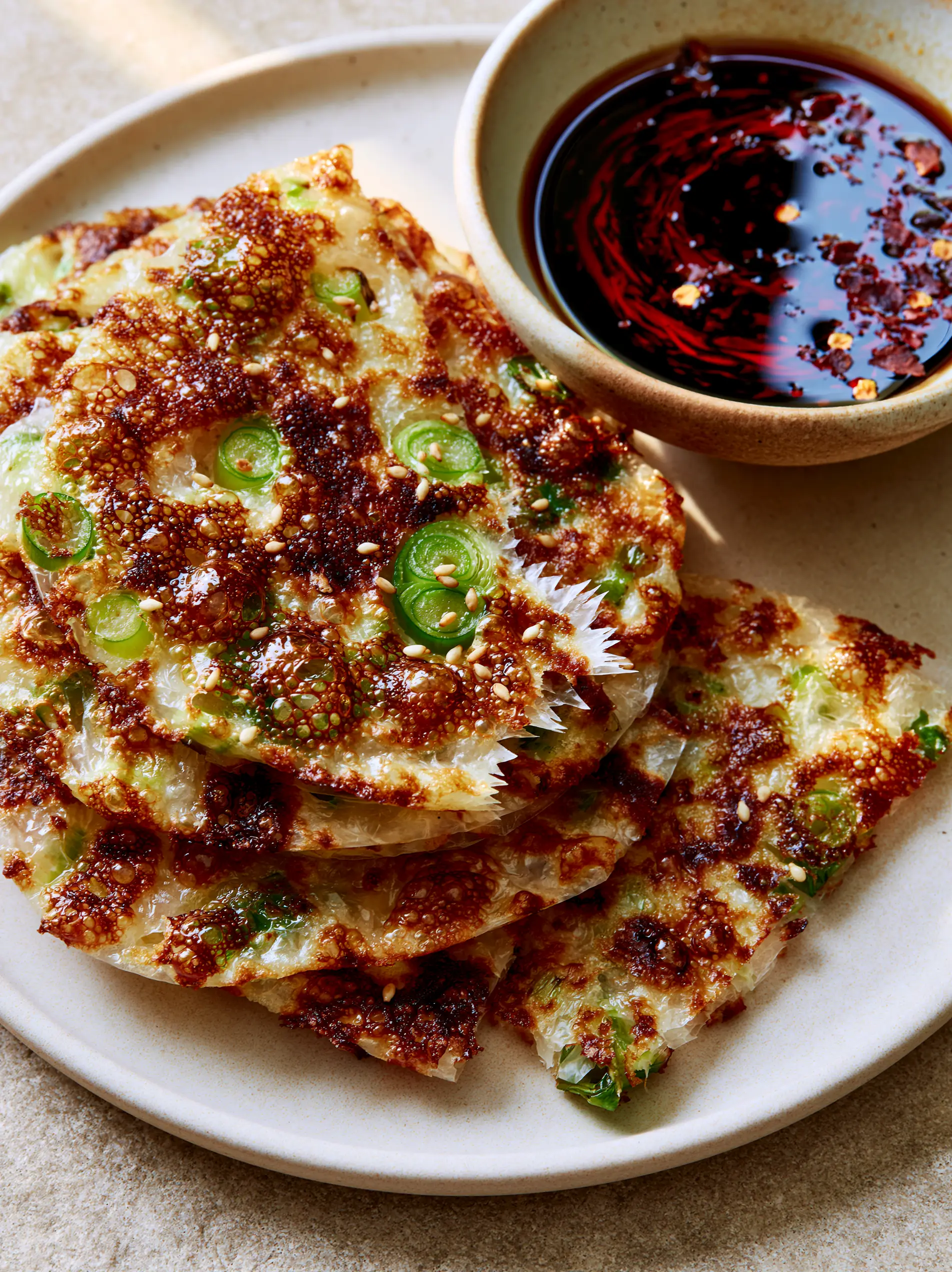 Macro shot of Rice Paper Scallion Pancakes with visible translucent layers and charred bubbles.