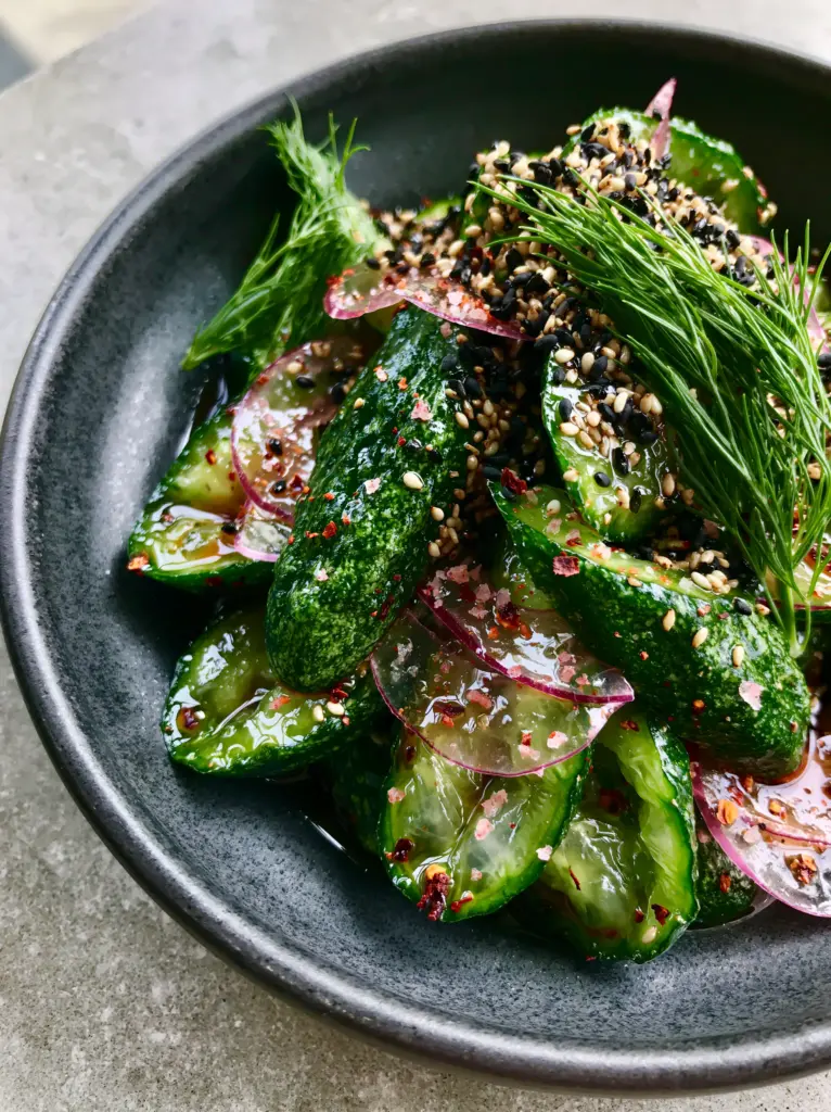 Cucumber Salad Recipes: The Ultimate Guide to Crispy, Glossy Persian Cucumbers 2 Close-up of thick-sliced Persian cucumbers with skin and translucent red onions, showcasing cucumber salad recipes.