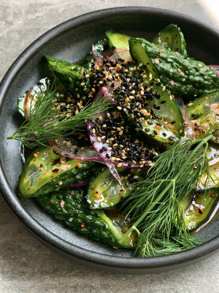 Cucumber Salad Recipes: The Ultimate Guide to Crispy, Glossy Persian Cucumbers 1 A handheld smartphone photo of a cucumber salad with toasted sesame seeds and fresh dill sprigs, illustrating cucumber salad recipes.