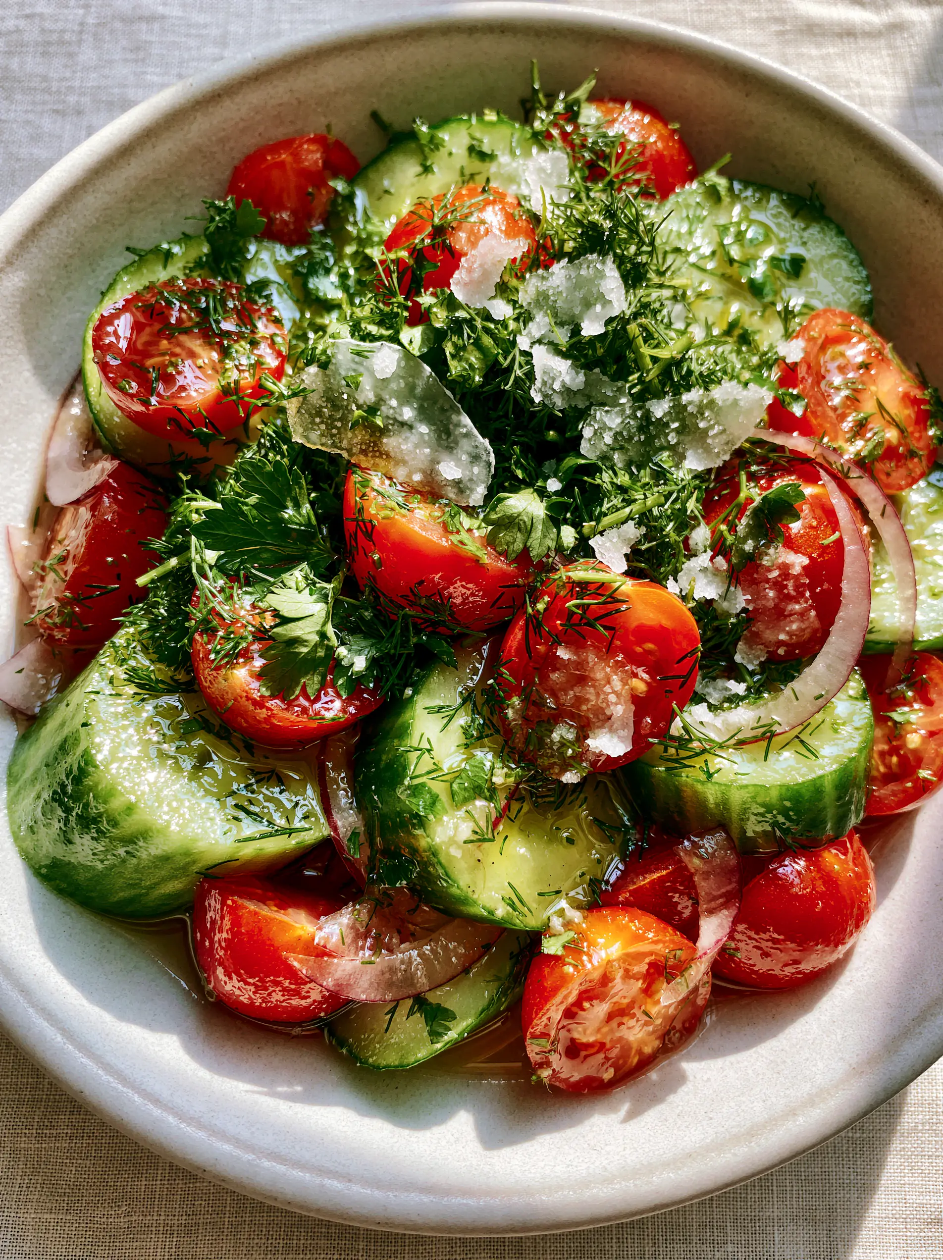 Cucumber and Tomato Salad with Flaky Maldon Salt 4 Extreme macro close-up of crunchy English cucumber rounds and juicy cherry tomatoes in a Cucumber and Tomato Salad.