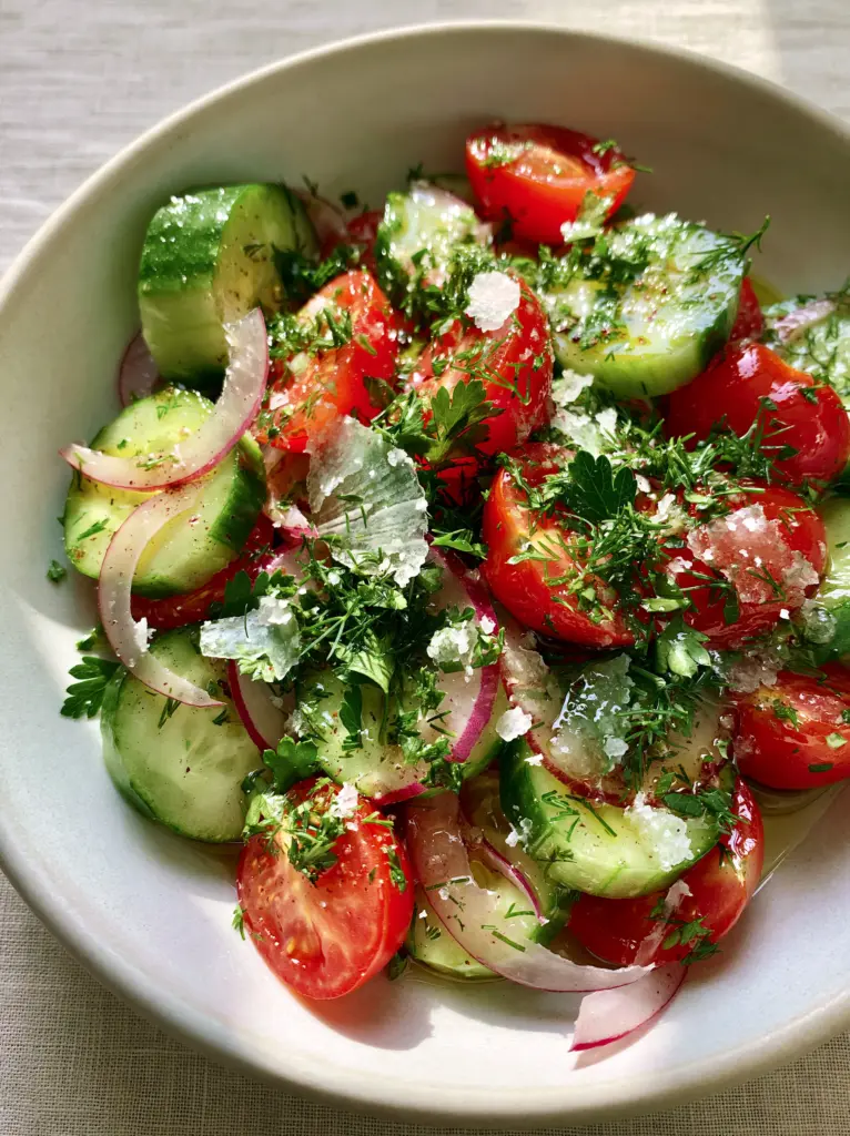 Cucumber and Tomato Salad with Flaky Maldon Salt 1 Top-down view of Cucumber and Tomato Salad featuring fresh dill, parsley, and paper-thin red onion slivers.