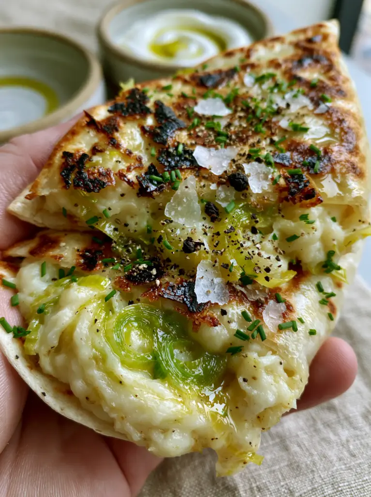 Leek and Potato Wraps: The Ultimate Crispy, Creamy Comfort Meal 2 Extreme close-up of a toasted flour tortilla with dark charred spots and sea salt flakes. (leek and potato wraps)