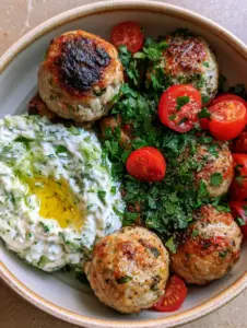 Succulent seared Greek Turkey Meatballs with crispy charred edges in a ceramic bowl. (Greek Turkey Meatballs)